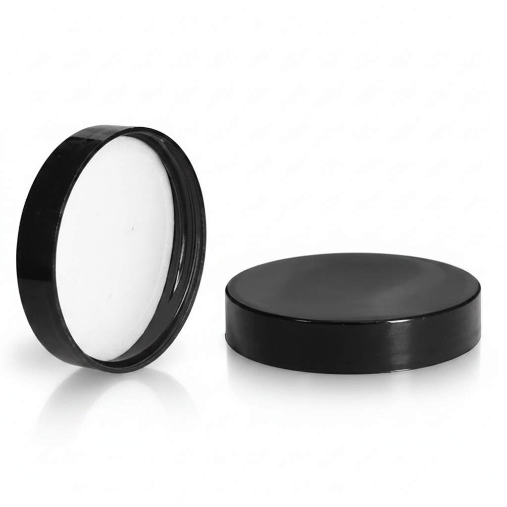 Black cosmetic jar lids on white background
