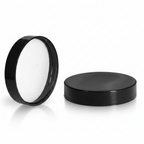 Black cosmetic jar lids on white background